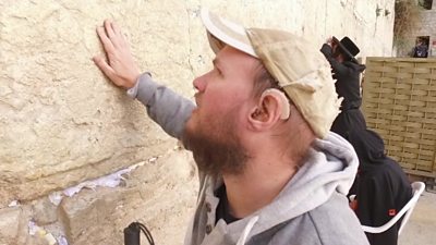 Tony Giles puts a hand against the Western Wall in Jerusalem