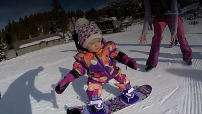 With her parents watching, this baby tries out snowboarding in Idaho for the first time.