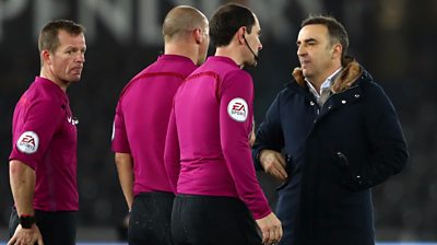 Swansea's Carlos Carvalhal talks to officuals