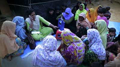 Women and children listening to Beggunor Lai (For Everyone) in Cox's Bazar