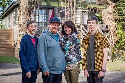 The Hackett family (Little Neil (HARVEY CHAISTY), Neil (JOHNNY VEGAS), Fiona (NIKY WARDLEY), Garth (OSCAR KENNEDY)(Image Credit: BBC/James Stack)