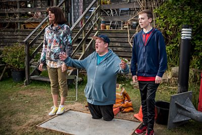 Fiona (NIKY WARDLEY), Neil (JOHNNY VEGAS), Little Neil (HARVEY CHAISTY)(Image Credit: BBC/James Stack)