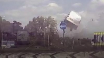 Van flies over roundabout in crash