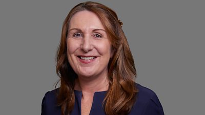 A woman with brown hair.