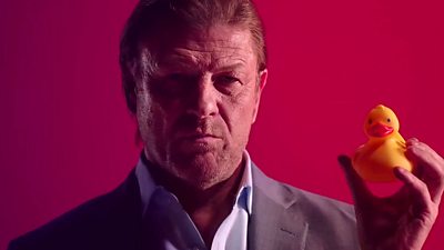 Actor Sean Bean holds a yellow rubber duck in a promotional video for Hitman 2