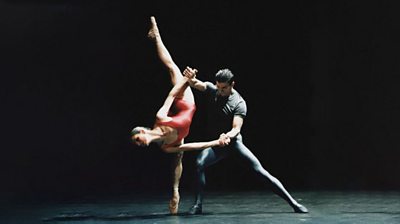 A male and female ballet dancer - the woman is balanced on one leg and is almost upside-down.