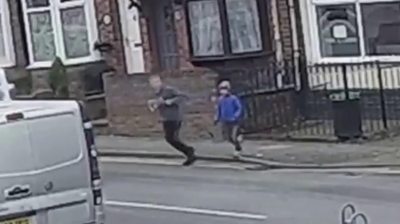 Boy running after dog