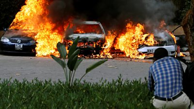 Cars are seen on fire at the scene of explosions and gunshots in Nairobi, Kenya January 15, 2019