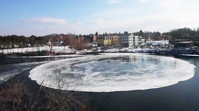 A floating ice disc on a river