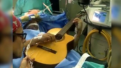 Musa Manzini with guitar during surgery