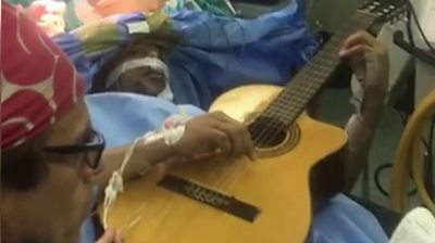 Jazz musician Musa Manzini was kept awake for part of his surgery to have a tumour removed.