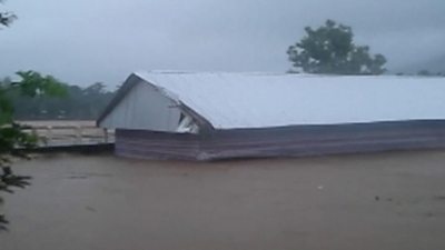 Still of longhouse being swept away