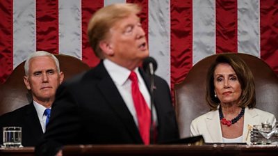 The US president earns a chant of 'USA, USA' from supporters but a disapproving stare from Nancy Pelosi.