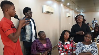 Barrister Catherine Edeh using a sign language interpreter at a BBC Media Action town hall debate