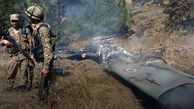 Pakistani soldiers near what appears to be aircraft wreckage