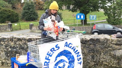 Sian Sykes from Surfers Against Sewage with plastic wrapping waste on Anglesey