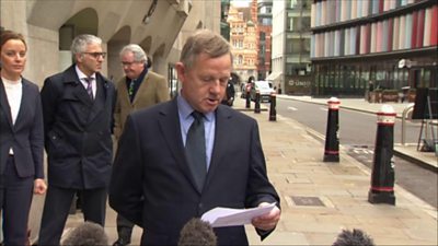 Andy Hill reads a statement outside court