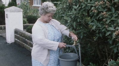 Woman filling bucket