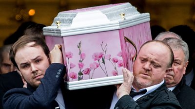 Two men carry Lauren Bullock's coffin