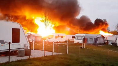 The fire started at about 05:30 at Ainmoor Grange Caravan Park in Stretton, Derbyshire