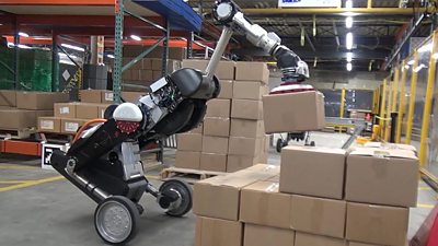A robot handling packages in a factory