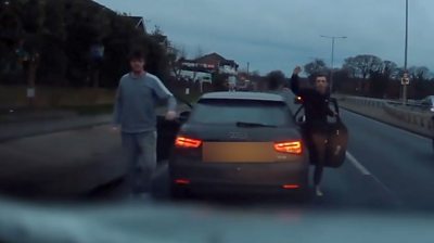 Men gesturing at another vehicle on A127