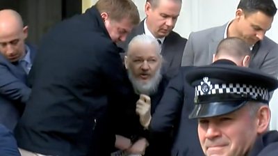 Assange with police
