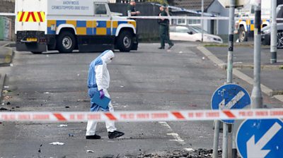 A forensic officer examines the scene of the violence in Londonderry