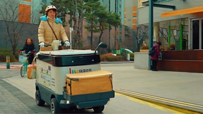 Korean lady driving a motorised fridge