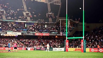 rugby posts lit green at match