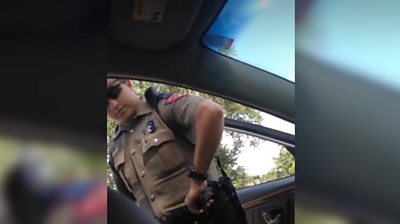 Police officer at opened car door