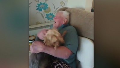 Man holding a very excited dog