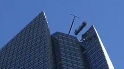 Window cleaners rescued from swinging lift