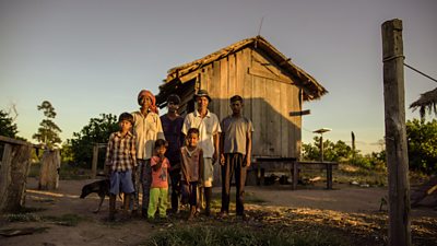 A Cambodian family with their newly constructed storm house, featured on Don't Wait For Rain