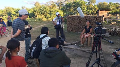 Interviewing a Cambodian woman who lost her father due to flash flooding