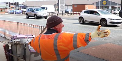 Street cleaner waving