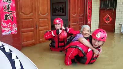 Old woman being rescued