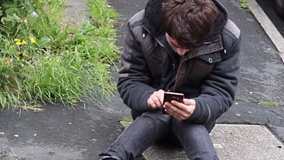 A former homeless person using a phone