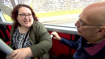 Passengers chatting aboard a bus in Plymouth