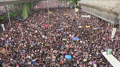 Thousands of protesters march through the city