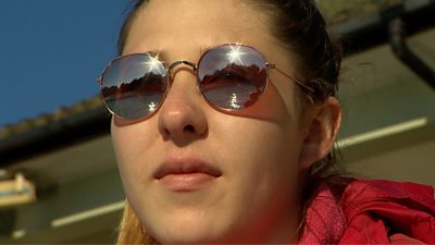Sun reflecting in girl's sunglasses