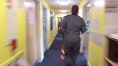 RAF personnel running in corridor