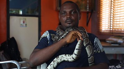 Mark Ofua with a python round his neck