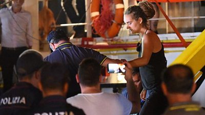 Carola Rackete, the 31-year-old Sea-Watch 3 captain, is escorted off the ship by police