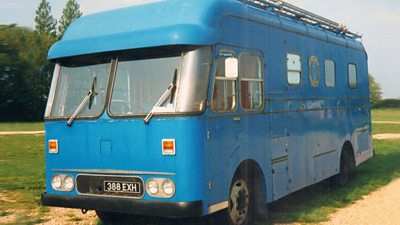 The outside broadcast van looking a little shabby and painted blue.