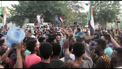 People wave flags and cheer in the streets