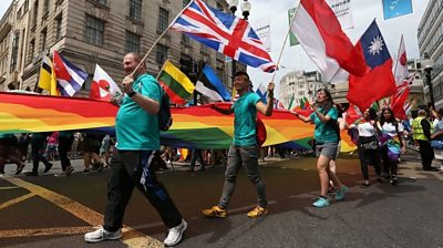 People take part in the Pride in London Parade in central London