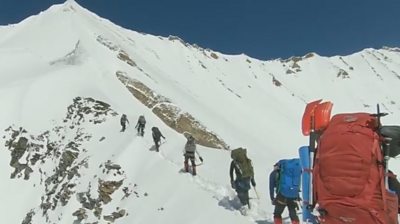 The video shows the climbers slowly making their way to the summit of Nanda Devi