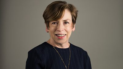 A woman wearing a navy blue top 