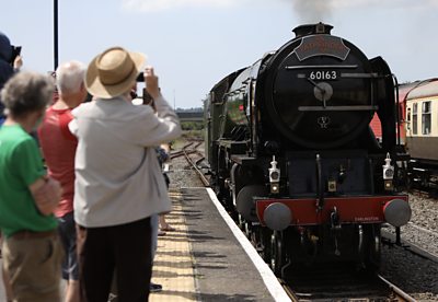 Onlookers snap pictures of the steam engine Tornado at Ferryside, Carmarthenshire